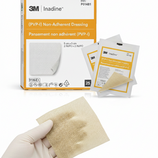 A box of 3M Inadine Non-Adherent Antimicrobial Dressings, with several individually wrapped dressings displayed in front of the box.